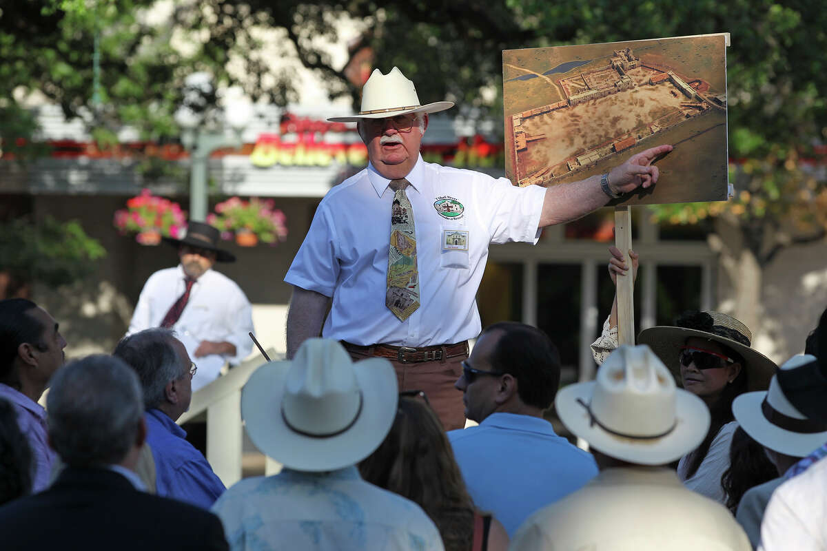John L. Hinnant points out locations on a drawing of the original Alamo compound boundaries as the city's Alamo Plaza Commission tours the site on May 28, 2014.