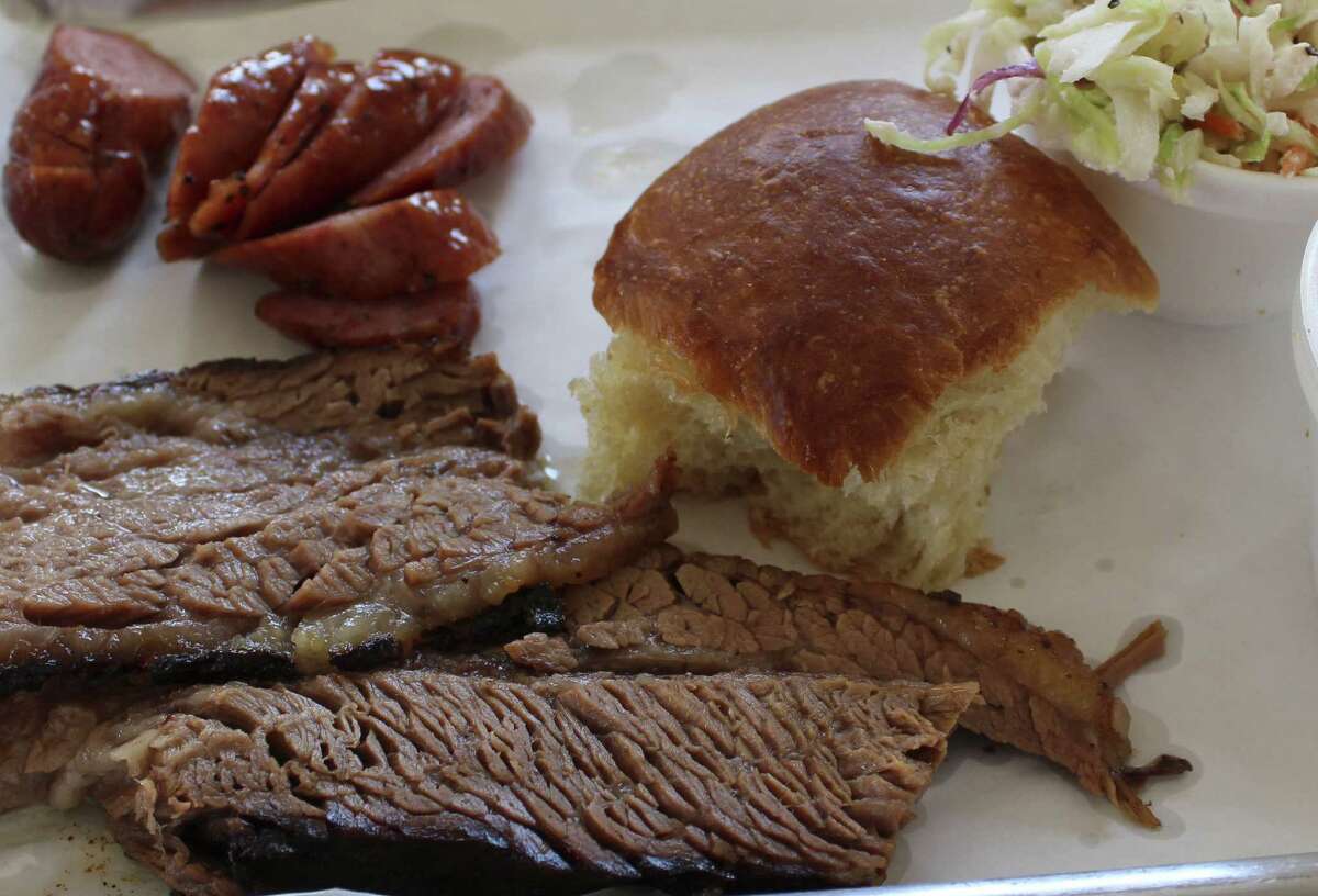 Smoke Shack BBQ + Southern Kitchen offers 1-, 2-, and 3-meat plates with two sides and a roll. Shown here are brisket, sausage and cole slaw.