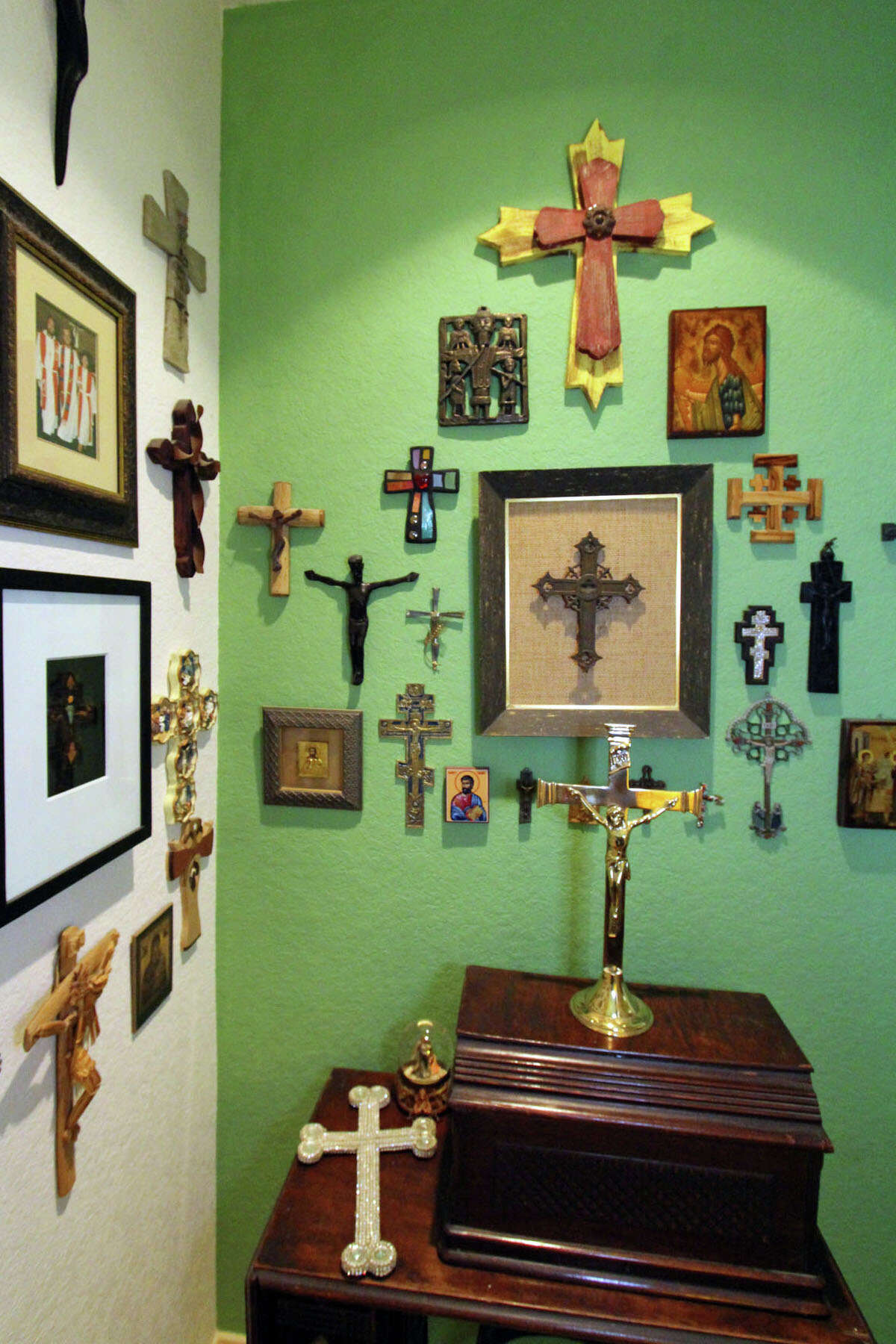 Crosses that Gini Bouzard has collected from all over the world hang on the hallway walls. Under them is the treadle sewing machine that went with her great-grandmother from Tennessee to Louisiana on a wagon. It still works.