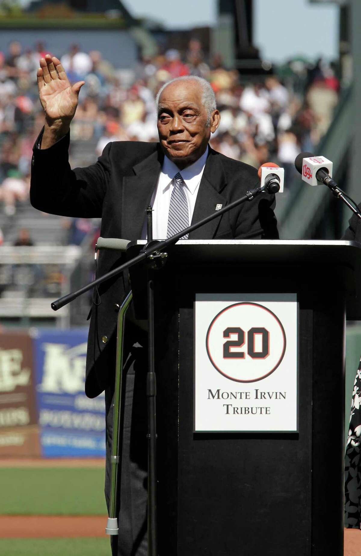 Former Giants Hall of Famer Monte Irvin, waves to the crowd as he had his jersey retired by the San Francisco Giants during a special pre-game ceremony before the Boston Red Sox interleague baseball game in San Francisco, Saturday, June 26, 2010. (AP Photo/ Tony Avelar)