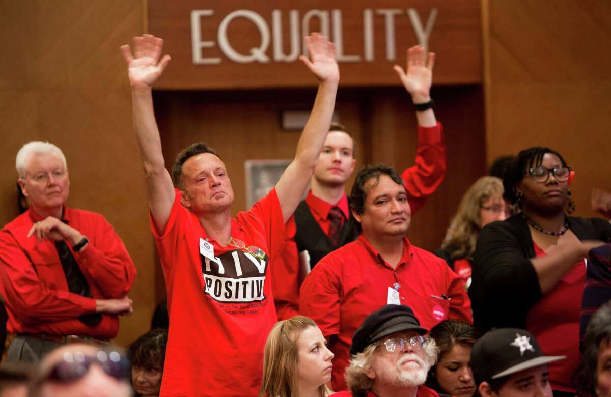 Supporters of the equal rights ordinance encourage speakers in favor of the proposal on Wednesday.