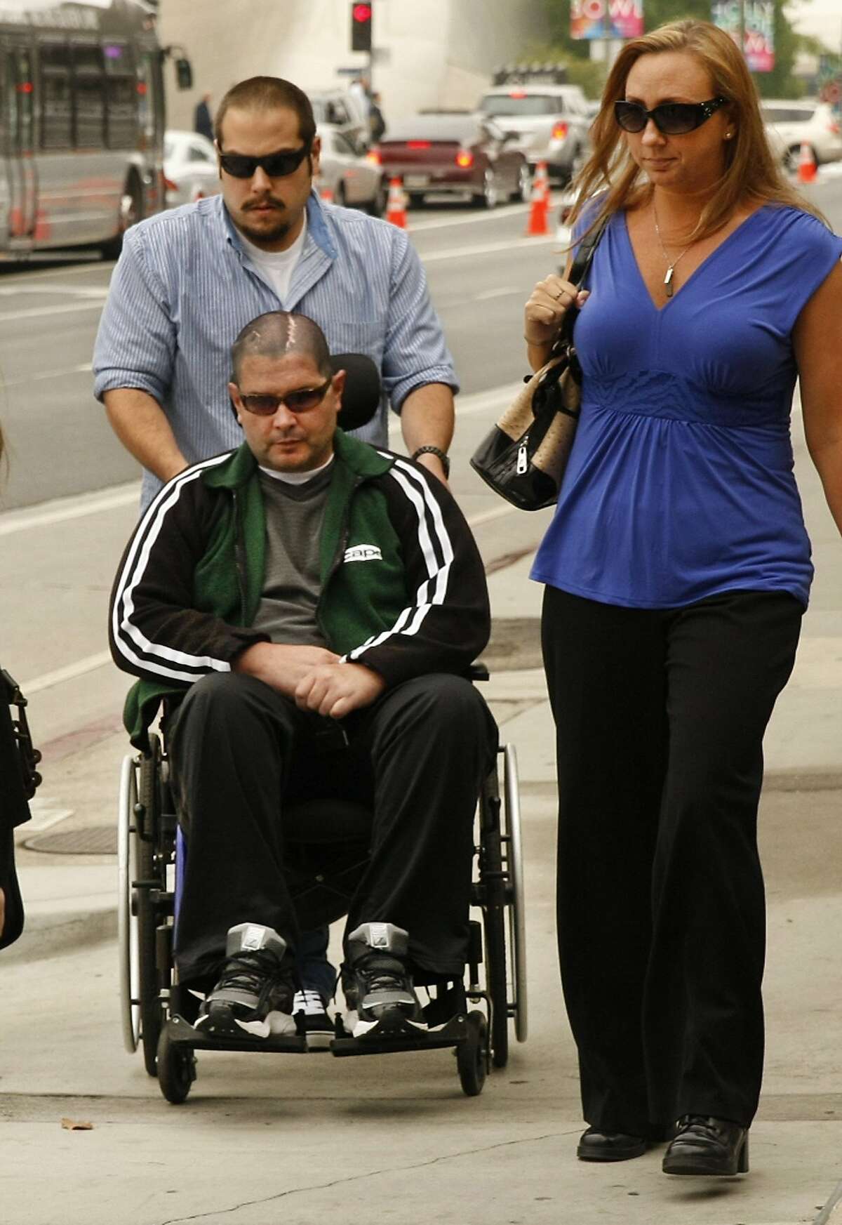 A wheelchair-bound Bryan Stow, assisted by a caregiver, is joined by family members as he enters the Los Angeles County Superior Courthouse on Wednesday, May 28, 2014, as jury selection continued into a second day for the trial of Bryan Stow's lawsuit against former Los Angeles Dodgers owner Frank McCourt and three team entities he created. (Al Seib/Los Angeles Times/MCT)