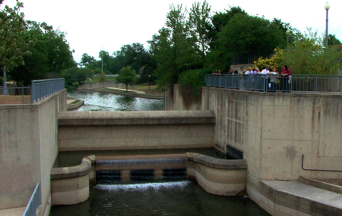 Water flows over a trough on a dam on the San Antonio River at East Josephine Street as water is diverted back into the banks of the river on Friday, May 15, 2009. The step was part of the Museum Reach of the river project.