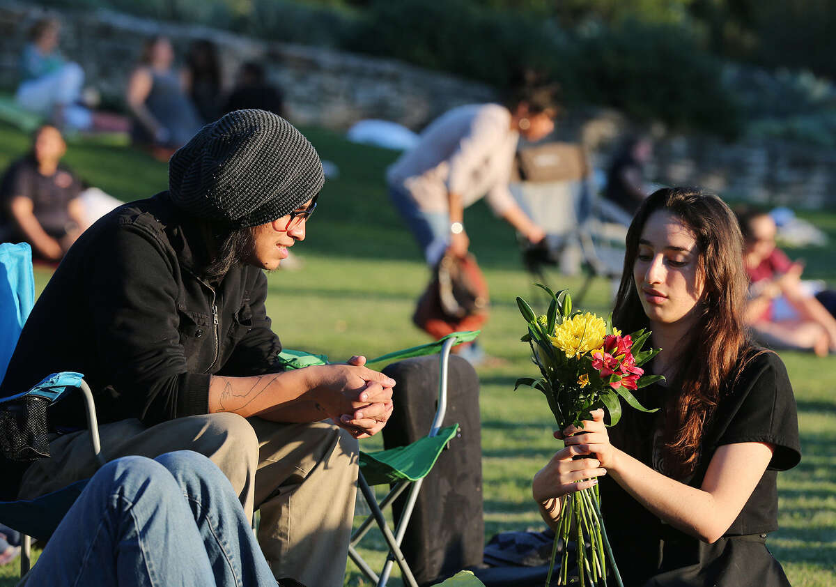 Benjamin Garcez (left) and Elda Flores arrange flowers for the actors before the start of Shakespeare in the Park's “Hamlet” at the San Antonio Botanical Gardens. It is produced by the Magik Theatre.