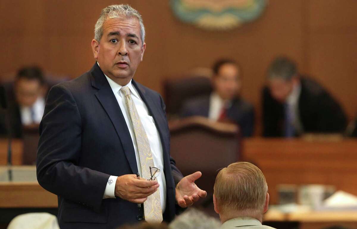 Rober Puente, President and CEO of SAWS, appears to have a question as San Antonio City Counsel members hear arguments and finally vote on the SAWS Water Impact Fees Proposal, at City Hall. Friday, May 29, 2014.