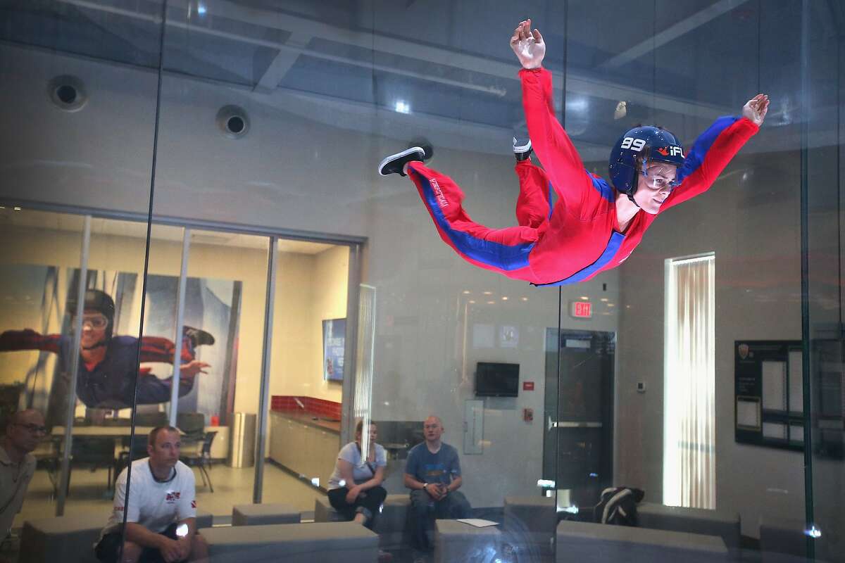 ROSEMONT, IL - MAY 29: Skydiver Lauren Wilkerson practices wind tunnel flying at the iFly indoor skydiving facility on May 29, 2014 in Rosemont, Illinois. Guests at the facility are introduced to the sensation of free-fall skydiving as they are lifted into the air by fans which generate an upward draft from 80 to 175 miles per hour inside a 14-foot-wide circular chamber. The company operates about 30 similar facilities around the globe which are used for military and competitive skydiver training as well as recreation. (Photo by Scott Olson/Getty Images)