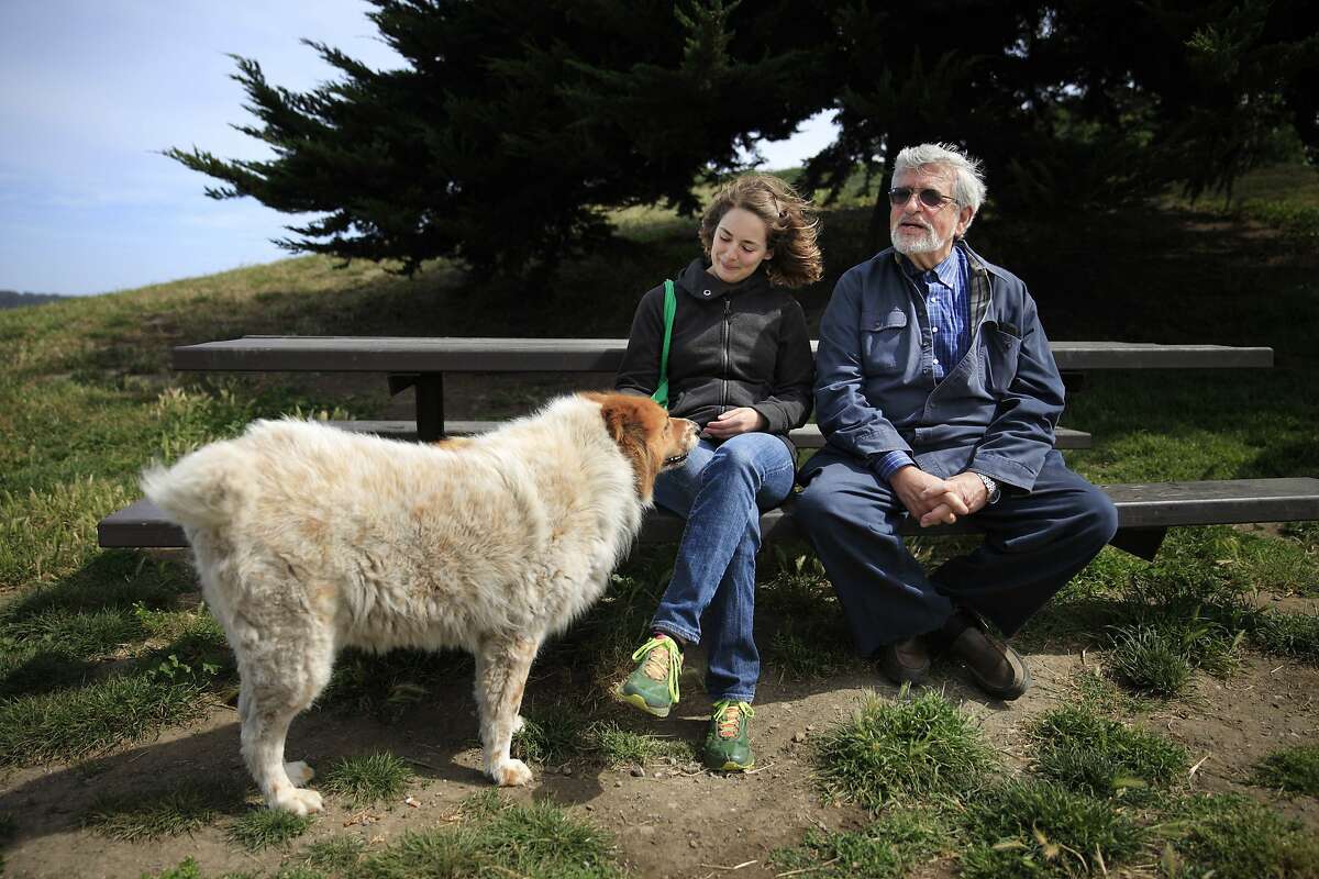 UC Berkeley Professor Richard Taruskin (right) and Nell Cloutier (left), UC Berkeley PhD candidate, talk on a bench as Cloutier greets a passing dog out for a walk at Point Isabel before Taruskin and Cloutier head out for a walk on Friday, May 16, 2014 in Richmond, Calif.