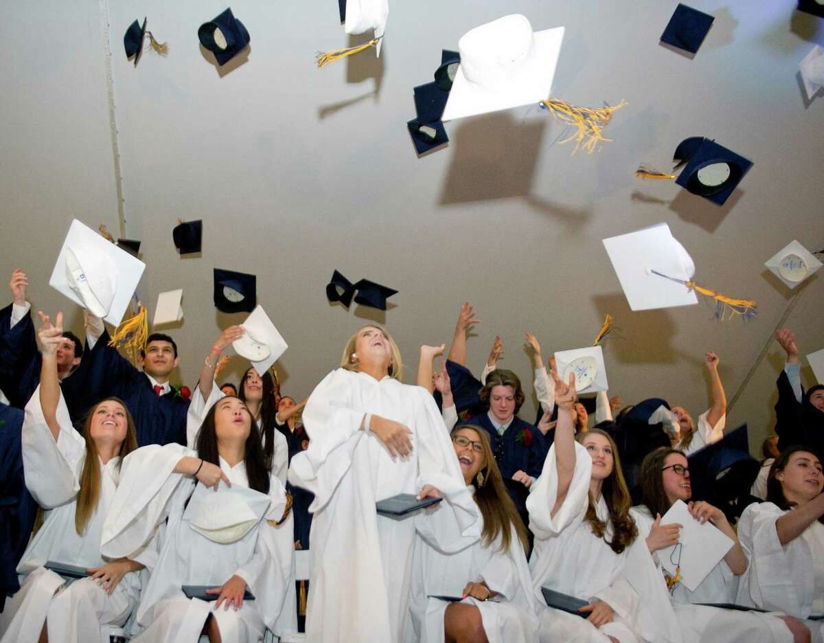 Graduates throw their caps during their commencement ceremony at King on Friday, May 30, 2014.