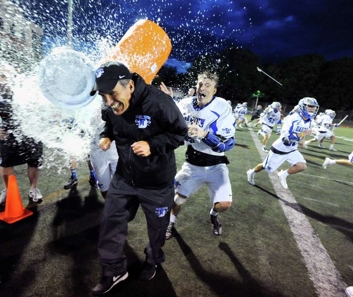 Darien boys lacrosse coach Jeff Brameier, left, gets the Gatorade bath from his player, Peter Lindley, right, after Darien won the FCIAC boys championship lacrosse match against Greenwich High School, 11-6, at Brien McMahon High School in Norwalk, Friday night, May 30, 2014.