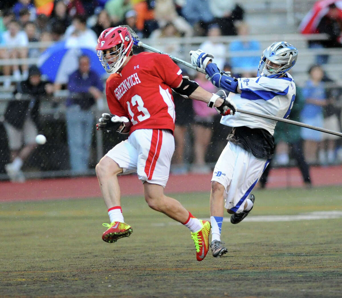 At right, Peter Lindley of Darien scores as Jack Nail of Greenwich defends during the FCIAC boys championship lacrosse match between Greenwich High School and Darien High School at Brien McMahon High School in Norwalk, Friday night, May 30, 2014. Darien won the championship defeating Greenwich, 11-6.