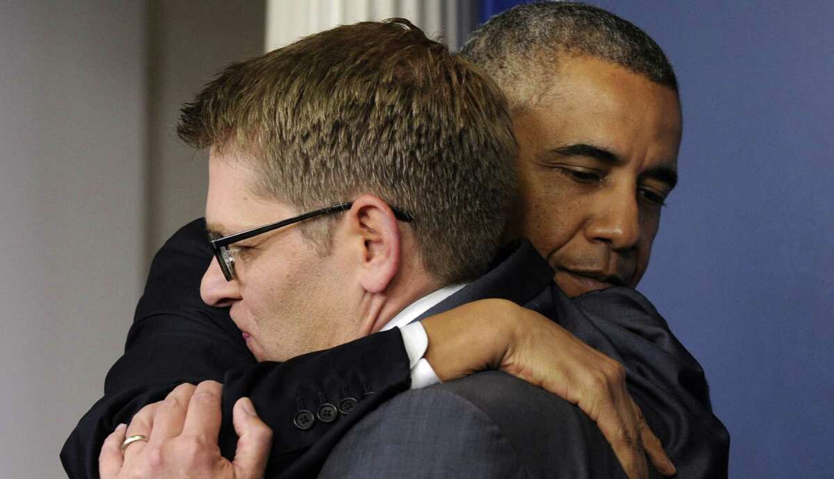 President Barack Obama hugs Jay Carney after announcing the press secretary's resignation.