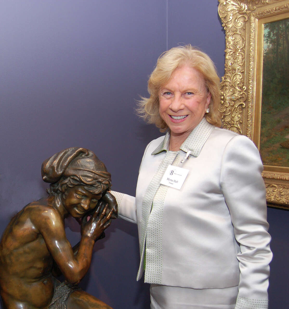 Jean-Baptiste Carpeaux's "Jeune Pecheur a la Coquille (Neapolitan Fisherboy)," was a gift to the Bruce Museum from Greenwich resident Myrna Haft who is seen here with the bronze sculpture.