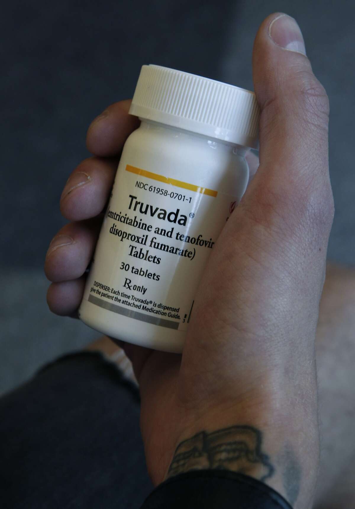 Adam Zeboski, an HIV counselor for the SF AIDS Foundation, holds a bottle of Truvada in San Francisco, Calif. on Friday, May 30, 2014. Zeboski has long supported the efficacy of the drug Truvada to prevent HIV infection and the CDC has finally endorsed its mainstream use.