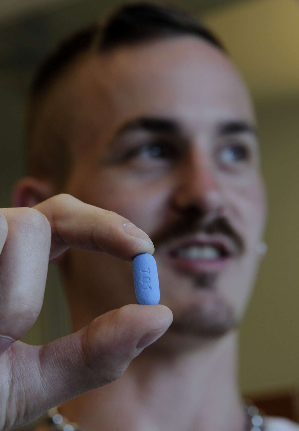 Adam Zeboski, an HIV counselor for the SF AIDS Foundation, holds a dose of Truvada in San Francisco, Calif. on Friday, May 30, 2014. Zeboski has long supported the efficacy of the drug Truvada to prevent HIV infection and the CDC has finally endorsed its mainstream use.