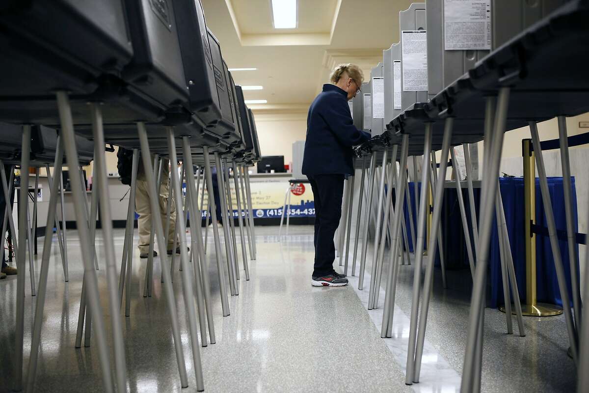 Rosalie Kingston of San Francisco fills out her ballot as early voting opens at City Hall in San Francisco, CA, Saturday May 31, 2014.
