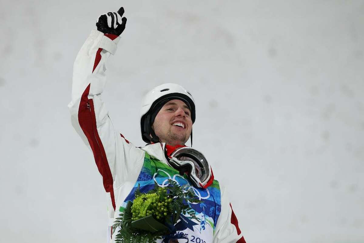 VANCOUVER, BC - FEBRUARY 14: Alexandre Bilodeau of Canada celebrates winning the gold medal during the flower ceremony for the Freestyle Skiing Men's Moguls on day 3 of the 2010 Winter Olympics at Cypress Freestyle Skiing Stadium on February 14, 2010 in Vancouver, Canada. Alexandre Bilodeau of Canada becomes the first Canadian to win a gold medal on home soil at the Winter Olympic Games. (Photo by Jamie Squire/Getty Images) *** Local Caption *** Alexandre Bilodeau