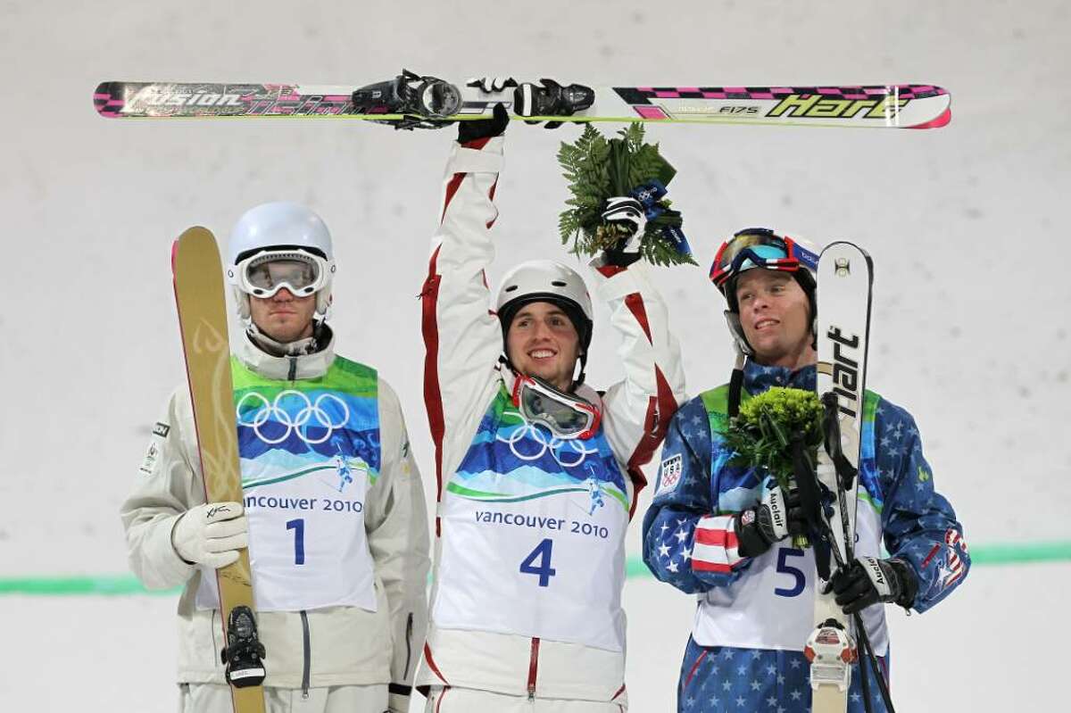 VANCOUVER, BC - FEBRUARY 14: (L-R) Dale Begg-Smith of Australia celebrates winning silver, Alexandre Bilodeau of Canada gold and Bryon Wilson of United States bronze during the flower ceremony for the Freestyle Skiing Men's Moguls on day 3 of the 2010 Winter Olympics at Cypress Freestyle Skiing Stadium on February 14, 2010 in Vancouver, Canada. Alexandre Bilodeau of Canada becomes the first Canadian to win a gold medal on home soil at the Winter Olympic Games. (Photo by Jamie Squire/Getty Images) *** Local Caption *** Dale Begg-Smith;Alexandre Bilodeau;Bryon Wilson
