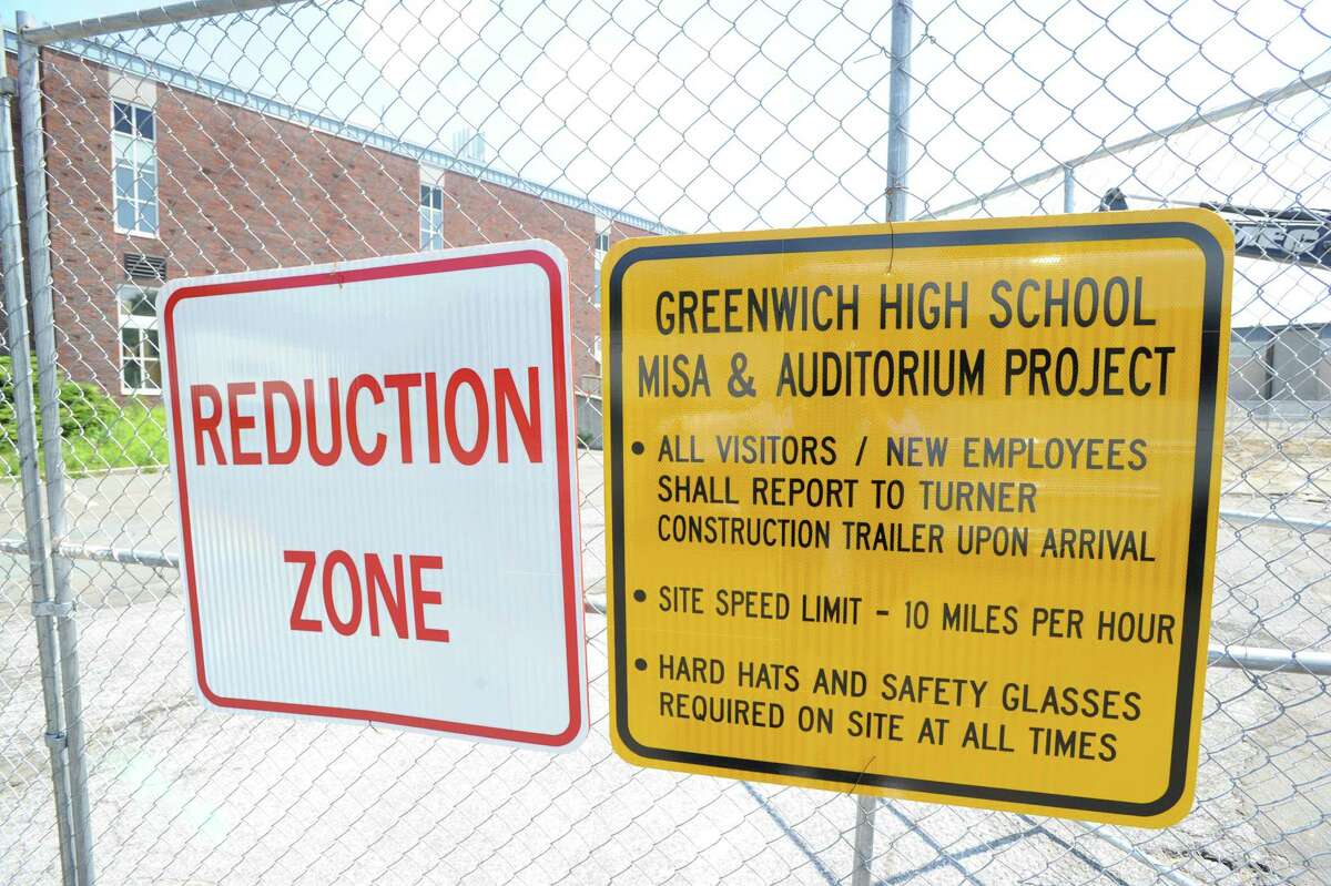 Signs on a fence in the construction zone for Greenwich High School music instruction space and auditorium project at the school, Tuesday afternoon, July 16, 2013.