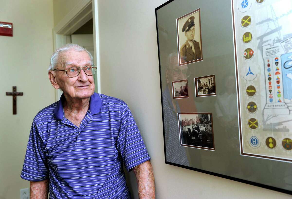 Matthew J. Czajka, 98, of Newtown, Conn. is a World War II veteran and DDay survivor. He reminisces about his experience at his home Tuesday, June 3, 2014. A framed map on his wall details his time in the war. Friday is the 70th anniversary of DDay.