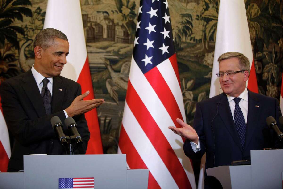 U.S. President Barack Obama and Poland's President Bronislaw Komorowski gesture towards each other at a news conference at Belweder Palace in Warsaw, Poland, Tuesday, June 3, 2014. (AP Photo/Charles Dharapak) ORG XMIT: POLD108