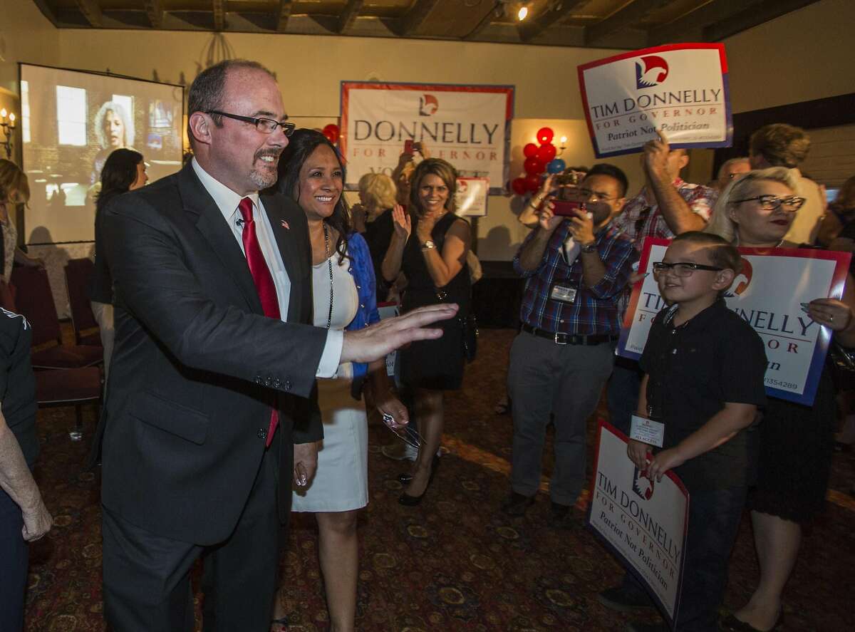 California Republican gubernatorial candidate Tim Donnelly greets with his supporters while wait for election results in the Hollywood, section of Los Angeles, Tuesday, June 3, 2014. Two Republicans are vying Tuesday for the chance to challenge Gov. Jerry Brown in November. (AP Photo/Ringo H.W. Chiu)