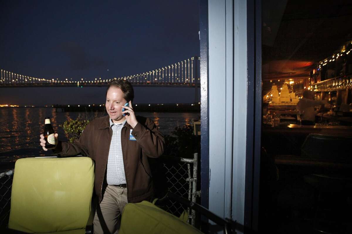 Yes on Prop. B Campaign Manager Jon Golinger takes a phone call as supporters gather for a party at Sinbad's Restaurant on Pier 2 in San Francisco, CA, Tuesday June 3, 2014.