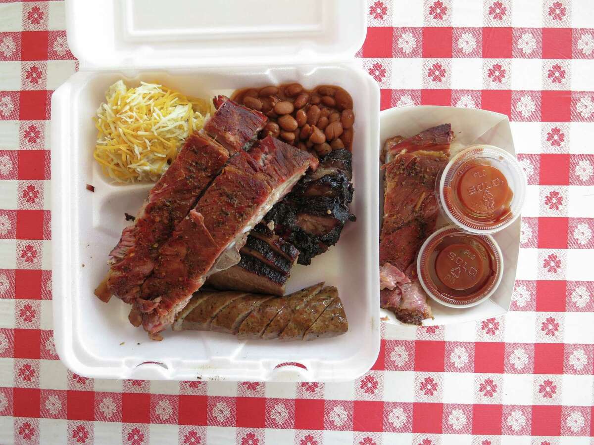 One of the staple menu items at the Wooden Spoke in Magnolia is the three-meat plate, consisting of brisket, sausage, ribs, ranch beans and ranch potatoes.
