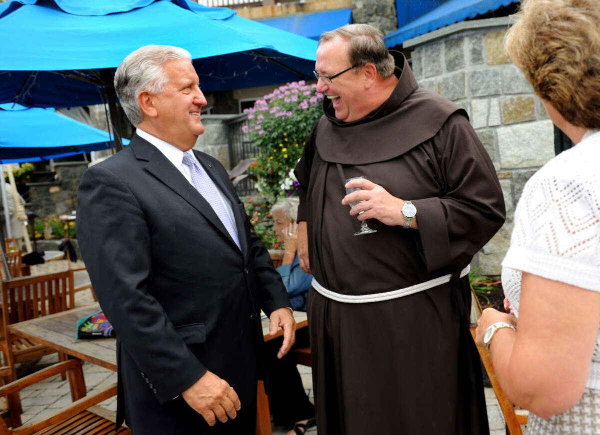 The Rev. Kevin Mullen, president of Siena College, chats with Albany Mayor Jerry Jennings during the Teresian House Foundation 23rd Annual Friendraiser Gala on Thursday, Aug. 1, 2013, at the Prime at Saratoga National Golf Club in Saratoga Springs, N.Y. Mullen received the Teresian Community Service Award and Jennings received special recognition. (Cindy Schultz / Times Union archive)