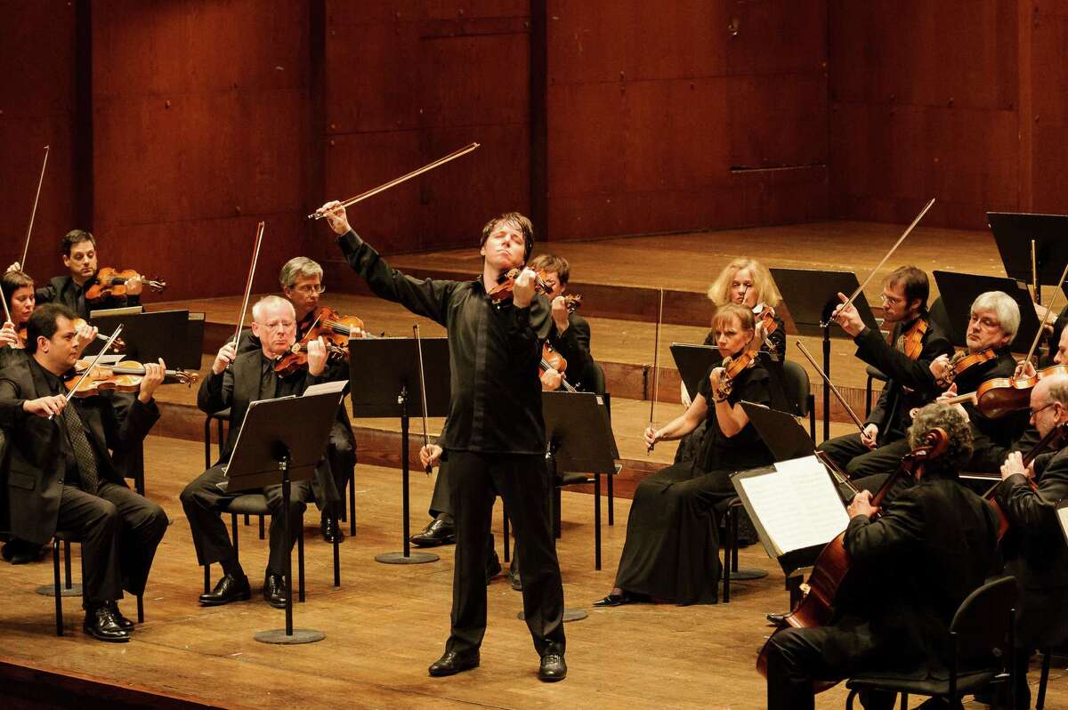 Violin star Joshua Bell is shown with the London-based Academy of St. Martin in the Fields orchestra, which he serves as music director. Bell will perform with the San Antonio Symphony for its 75th anniversary special concert.