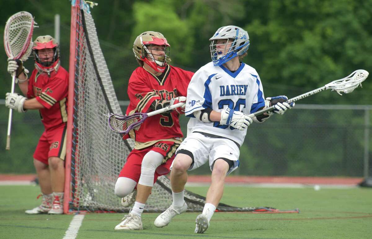 Stratford's Brendan Miller, #9, defends Darien's Hudson Hamill, #36, during the Class M boys lacrosse state playoff game between Stratford and Darien high schools on Wednesday, June 4, 2014, played at Darien High School, Darien, Conn. Stratford's Steven Tobey, #1, is in goal.