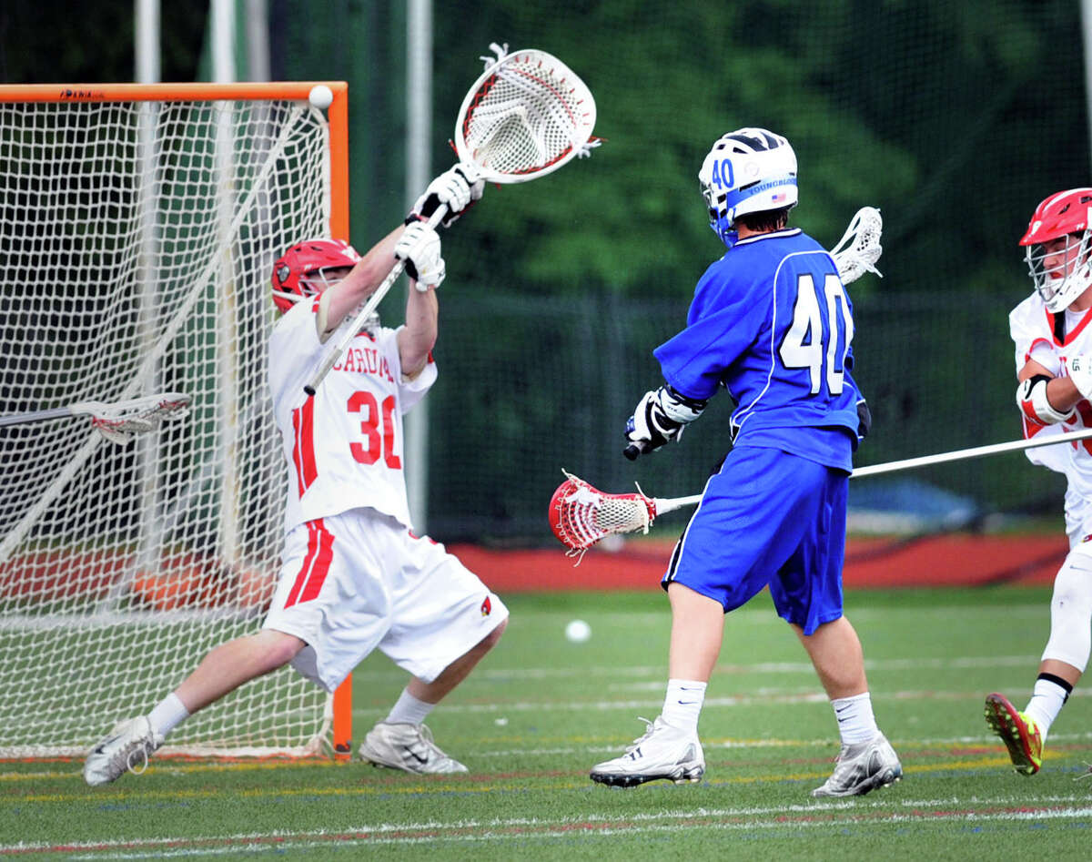 At right, Fairfield Ludlowe's Trevor Demilt (#40) hits the crossbar on a shot from point-blank range as Greenwich goalie Tommy Rogan defends during the state playoff lacrosse match between Greenwich High School and Fairfield Ludlowe High School at Greenwich, Wednesday, June 4, 2014.