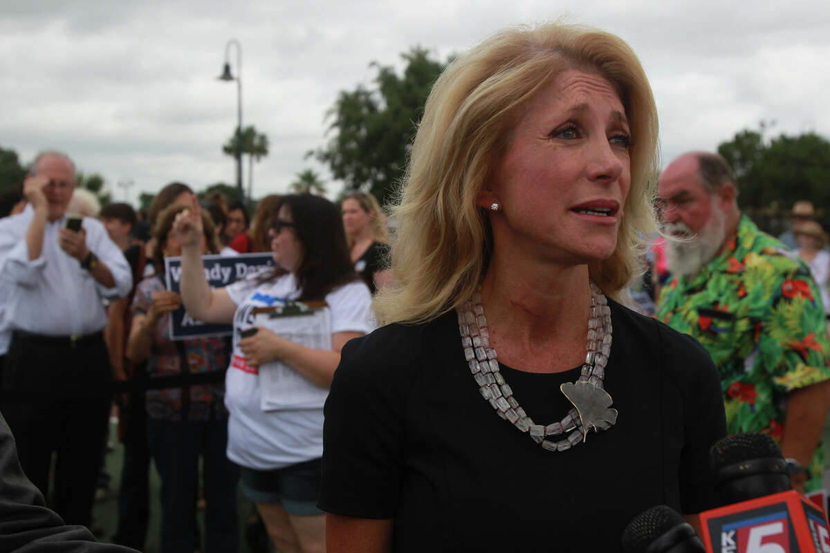 Texas Senator and gubernatorial candidate Wendy Davis speaks with the media Thursday June 5, 2014 at Woodlawn Lake Park. Davis spoke about her Republican opponent and issues like equal pay for women. Davis also showed her support for the San Antonio Spurs.