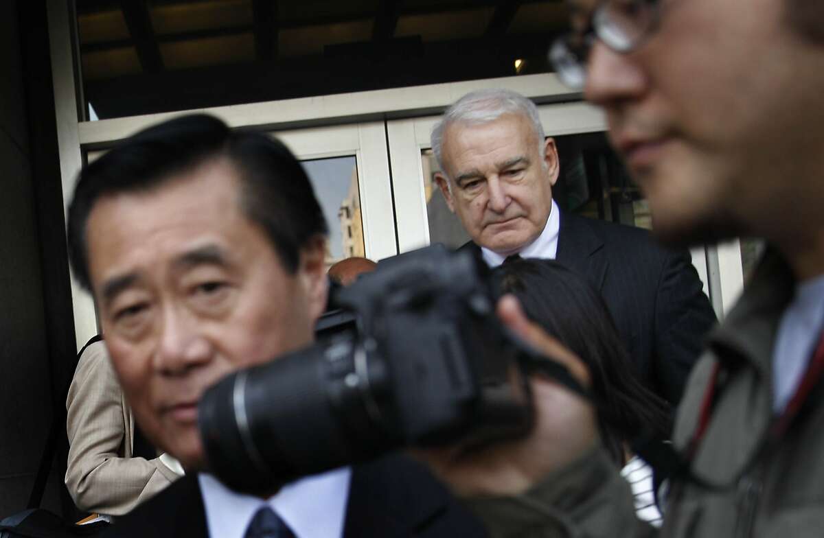 Suspended California state Sen. Leland Yee (left) and attorney James Lassart (right) leave the Phillip Burton Federal Building and United States Courthouse after Yee's arraignment on Tuesday, April 8, 2014, in San Francisco, Calif.