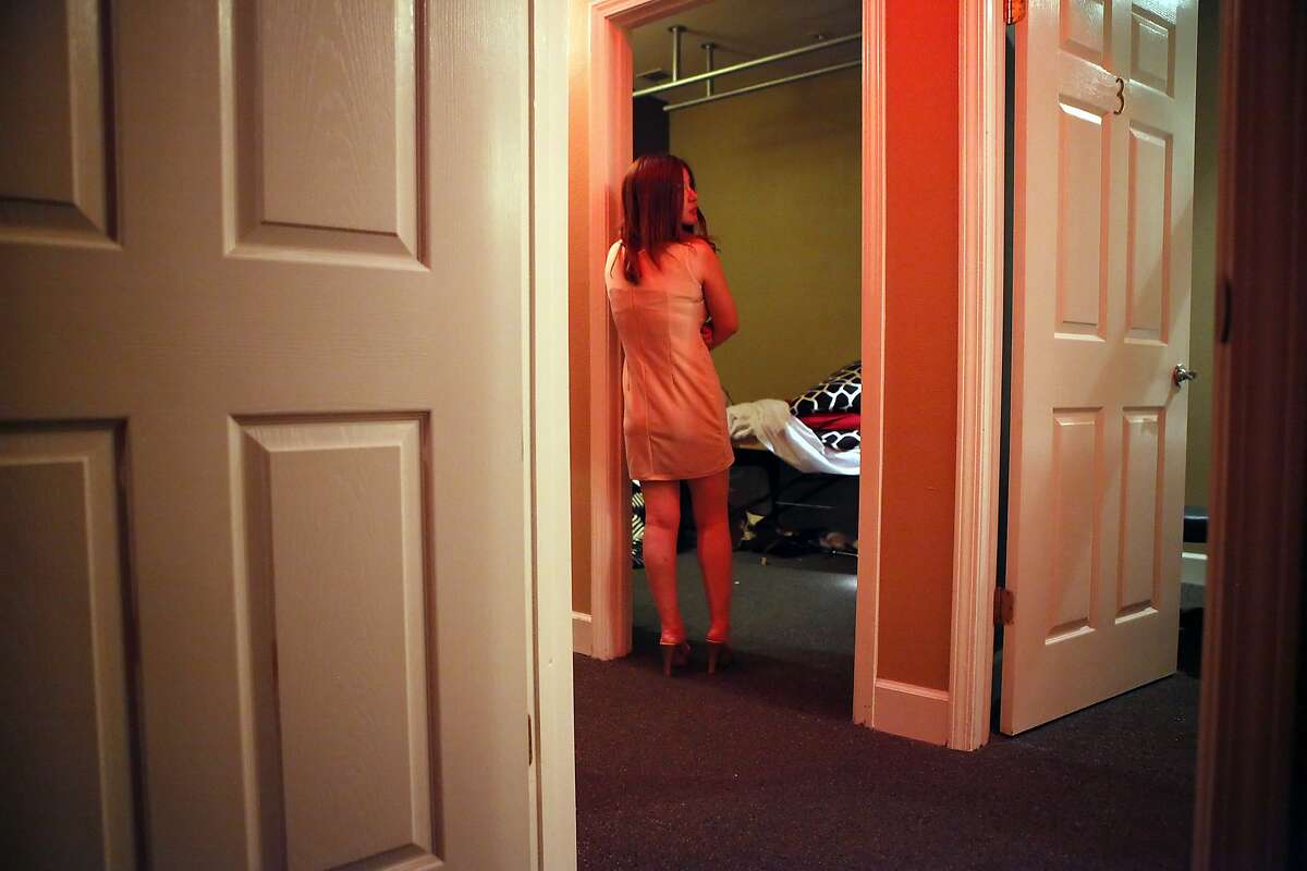 A scantly clad worker stands in a hallway during a surprise inspection of the Nirvana Healthcare Center massage parlor in San Francisco, CA, Friday, March 14, 2014. Inspectors with the San Francisco Department of Public Health, working in tandem with the SFPD's Special Victims Unit and SFFD building inspectors, conducted unannounced inspections of a select group of massage parlors in San Francisco looking for violations, sexual misconduct and evidence of human trafficking.