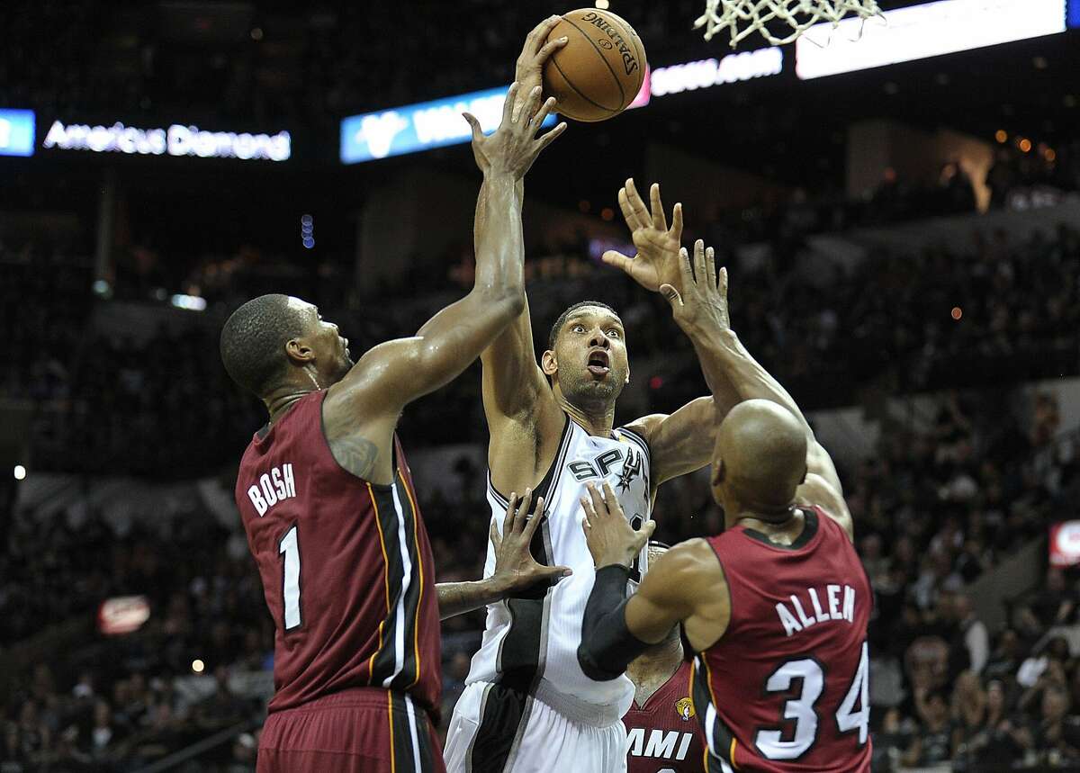 The San Antonio Spurs' Tim Duncan takes a shot over the Miami Heat's Chris Bosh (1) and Ray Allen (34) during the first half in Game 1 of the NBA Finals on Thursday, June 5, 2014, at the AT&T Center in San Antonio. (Michael Laughlin/Sun Sentinel/MCT)