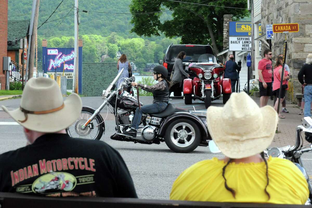 Ronald and Lynne Colby of East Hampton, Massachusetts watch the passing traffic as motorcycles fill the streets for the 2014 Americade on Thursday June 5, 2014 in Lake George, N.Y.