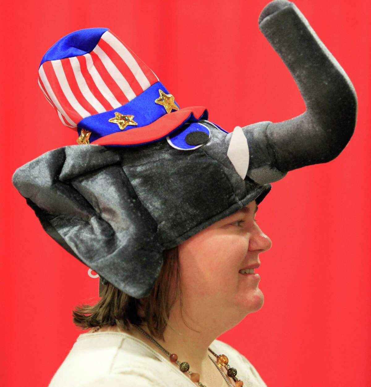 Tea Party volunteer Margaret Foland, from Arlington, Texas, wears another style of elephant hat available in the vendor area on the convention center floor as people arrive, Wednesday, June 4, 2014, for the Republican Party of Texas state convention (starting Thursday, June 5) at the Fort Worth Convention Center in Fort Worth, Texas. (AP Photo/Star-Telegram, Paul Moseley) MAGAZINES OUT; (FORT WORTH WEEKLY, 360 WEST); INTERNET OUT.