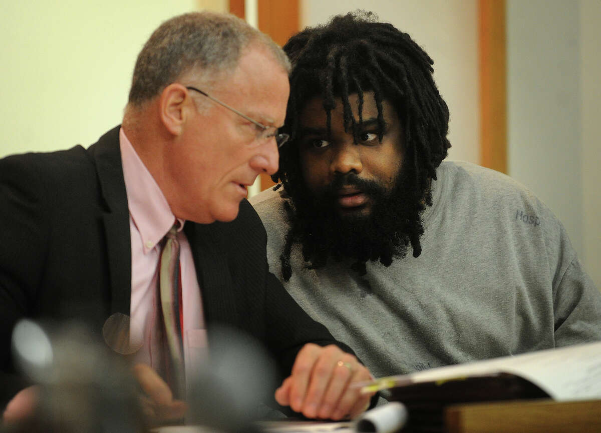 Defendant Tyree Lincoln Smith, right, talks with his attorney, public defender Joseph Bruckmann, during his murder trial in state Superior Court in Bridgeport, Conn. on Tuesday, July 9, 2013.