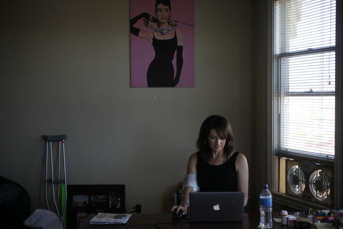 Beth Rifkin, 46, does work on her computer May 26, 2014 in her friend's apartment in San Francisco, Calif. Rifkin, who is a freelance writer, has been staying with a friend of hers since early May. She was given less than 24 hours to move out of a room she was living in through Airbnb in March after two months of living there with an established contract, according to Rifkin. Soon after moving into her friend's place temporarily, she had to be hospitalized due to an infection in her bone that had been festering from earlier infection she had in her foot in the fall, unbeknownst to Rifkin. Two and a half weeks and one surgery later, Rifkin was released from the hospital May 22 for a week. She will be re-admitted for a second surgery on May 29. Rifkin believes that part of the reason her infection came back in full force was due to the stress of not knowing her housing situation, causing pressure on her immune system.