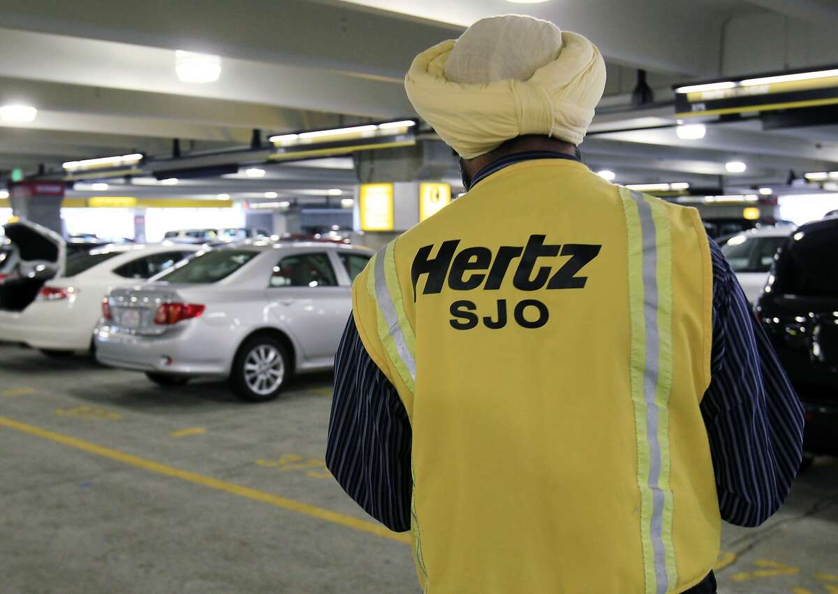 FILE - In this May 9, 2011 file photo, a Hertz rental car worker checks out cars at San Jose International Airport in San Jose, Calif. Hertz Global Holdings Inc. says it has to review its financial reports from the past three years after an audit by the car rental company found accounting errors. (AP Photo/Paul Sakuma, File)