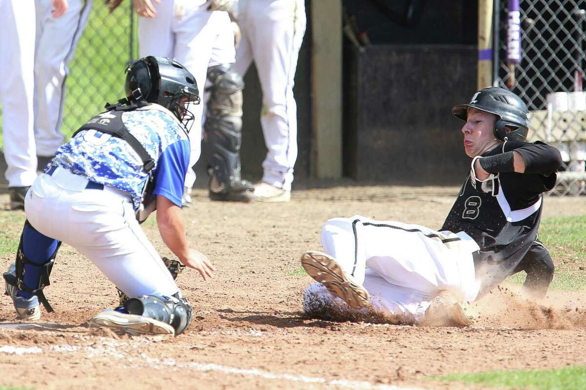 Jonathan Law High School's # 8 Rob Griswold slides to homeplate on a steal against Darien High School's catcher # T.J. Adiletta during Friday afternoon match-up. Griswold was safe on play.