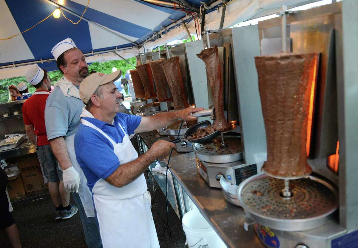 Peter Soumakis, left, of Patterson, N.Y., and Sprio Rountos, of Danbury, prepare a gyro at The Greek Experience Festival 2014 at Assumption Greek Orthodox Church in Danbury, Conn. Friday, June 6, 2014. The festival featured traditional Greek food and pastries, shopping, live music, and traditional dancing. The Greek Experience continues Saturday from noon to 11 p.m. and Sunday from noon to 9 p.m.