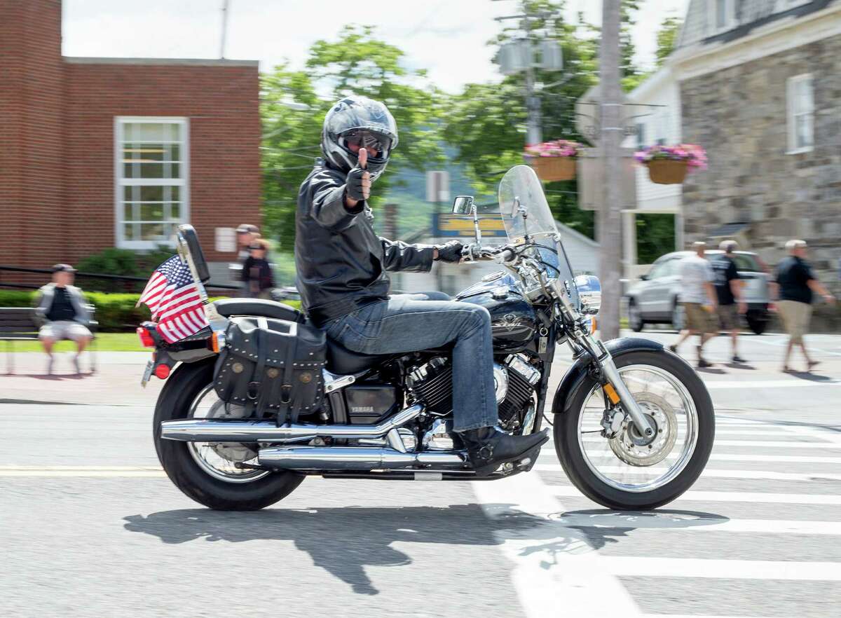 A motorcyclist gives the thumbs up while riding along Canada Street Friday, June 6, 2014, in Lake George, N.Y., during the Americade motorcycle rally. 