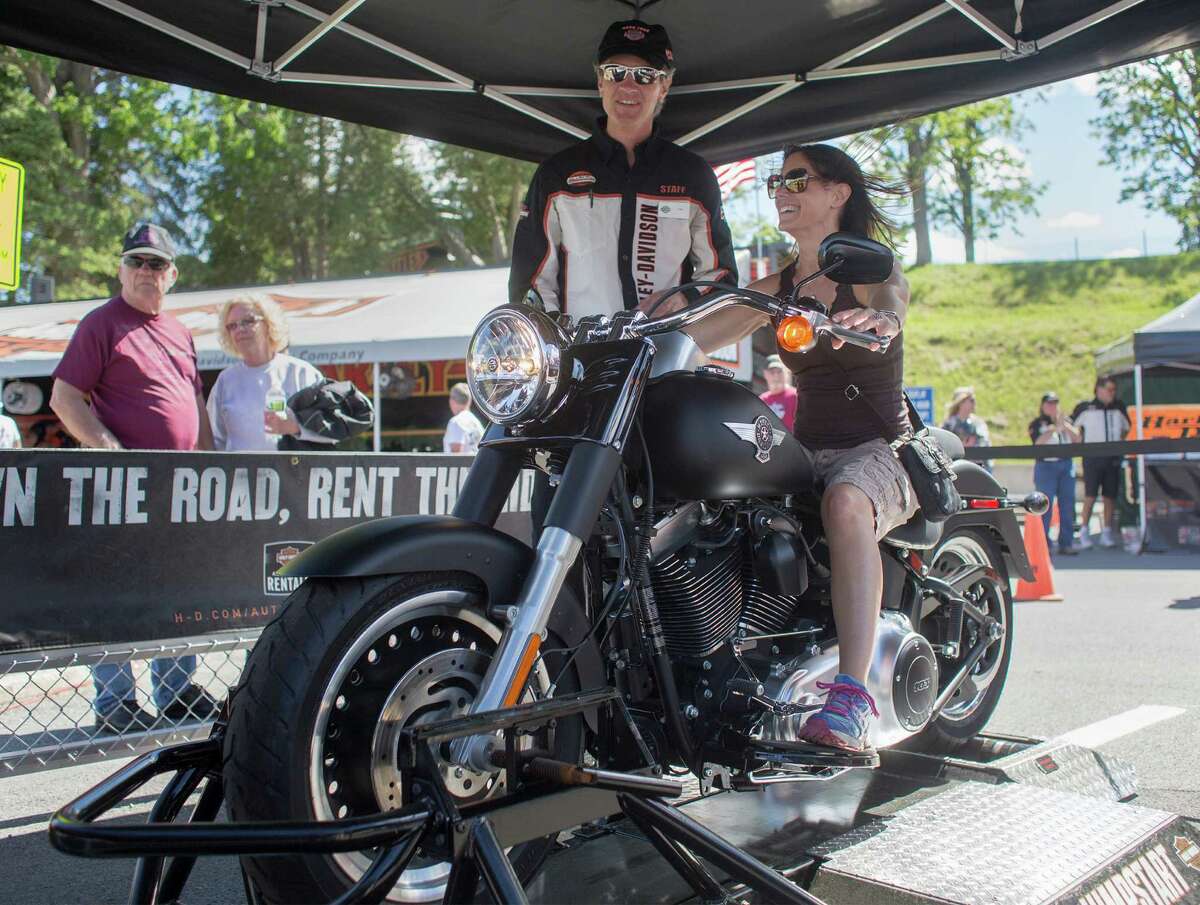 Amy Grant test rides a new Harley Davidson motorcycle on a dynamometer platform outside the Harley Davidson tent during the Americade motorcycle rally in Lake George, N.Y. on Friday, June 6, 2014.