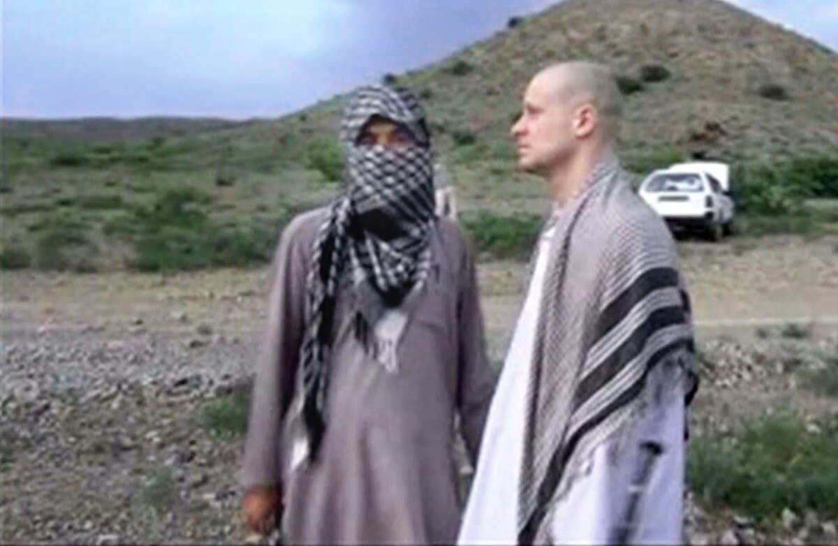FILE - In this Saturday, May 31, 2014 image made from video obtained from the Voice Of Jihad website, which has been authenticated based on its contents and other AP reporting, U.S. Army Sgt. Bowe Bergdahl, right, stands with a Taliban member in eastern Afghanistan. On Wednesday, June 4, 2014, the Taliban released the video showing the handover of Bergdahl to U.S. forces in eastern Afghanistan. Bergdahl went missing from his outpost in Afghanistan in June 2009 and was released from Taliban captivity on May 31, 2014 in exchange for five enemy combatants held in the U.S. prison in Guantanamo Bay, Cuba.(AP Photo/Voice Of Jihad)