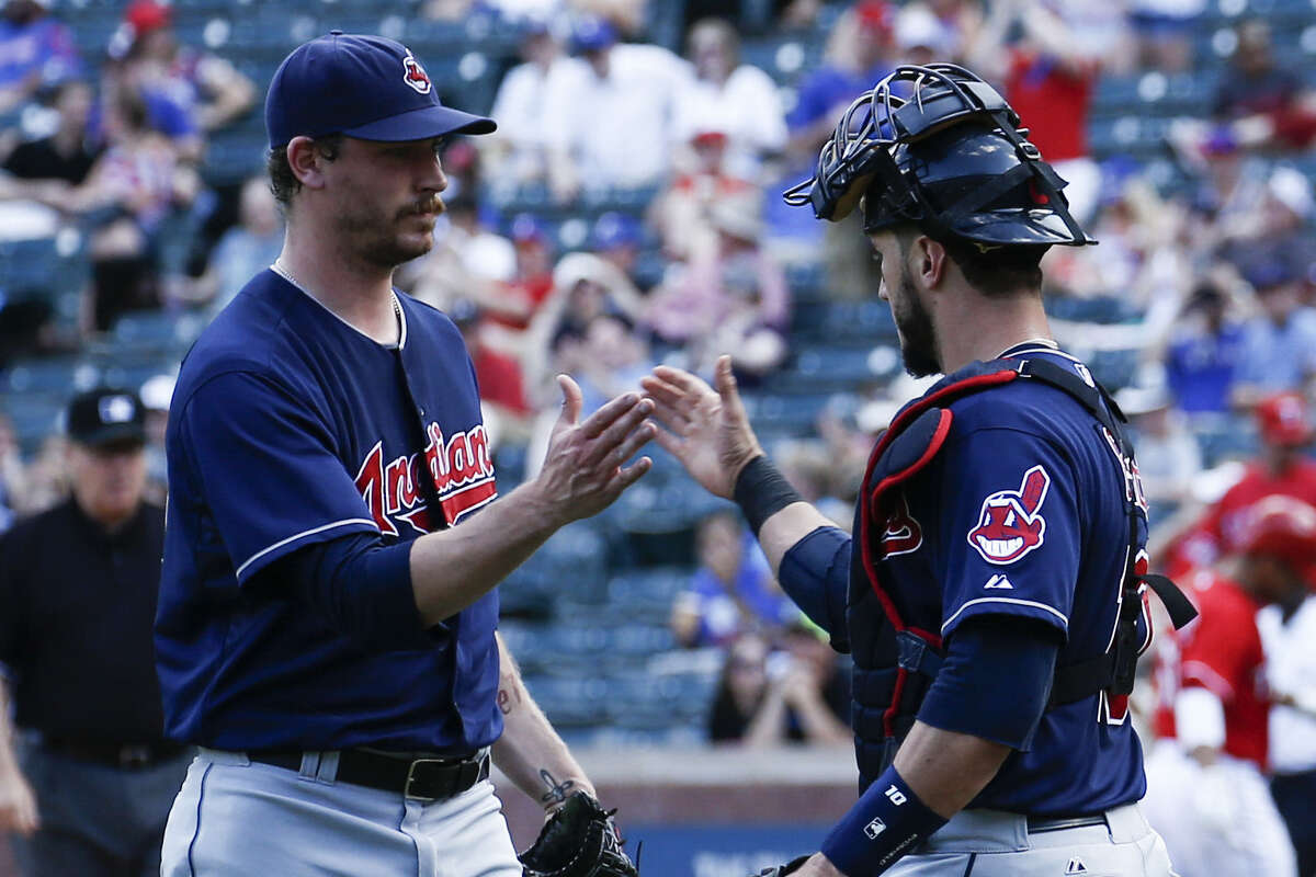 Indians reliever John Axford (left) and catcher Yan Gomes congratulate each other after Saturday's win.