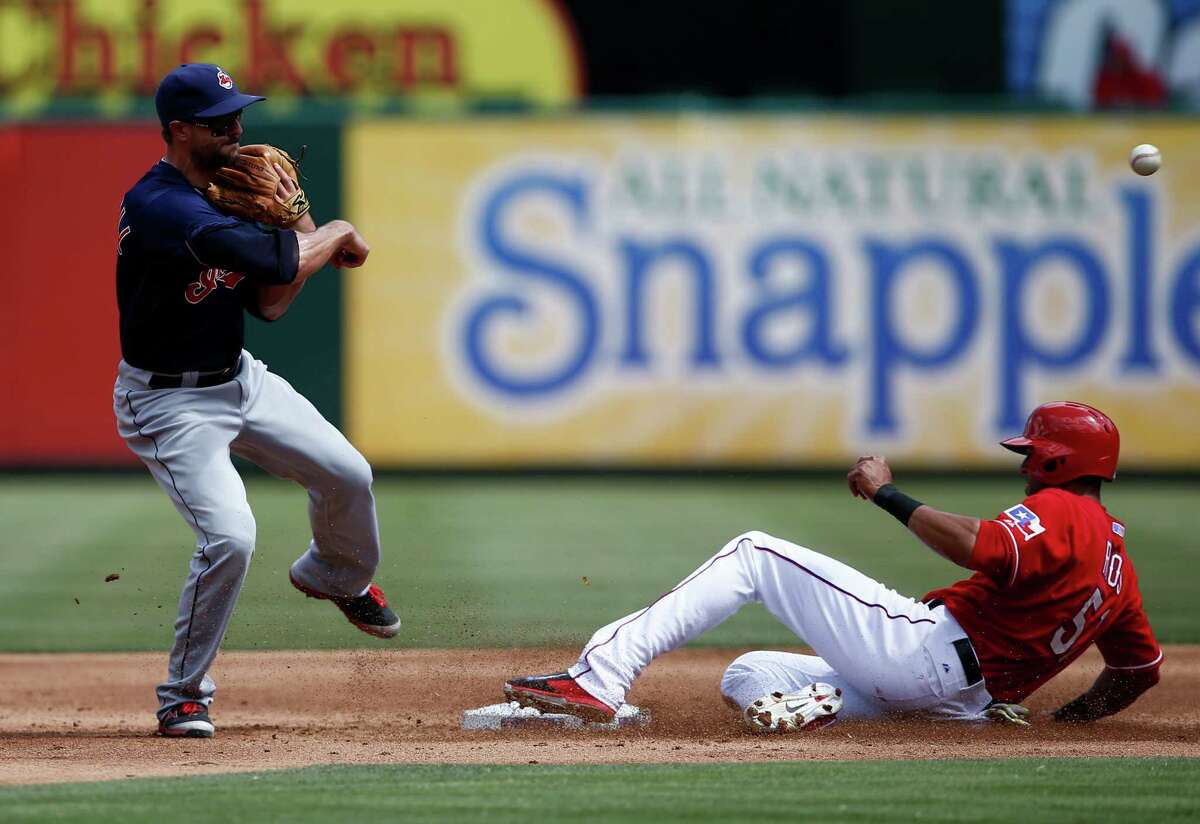 Cleveland Indians third baseman Lonnie Chisenhall, left, throws to first after forcing out Texas Rangers' Alex Rios, right at second base on a hit by Rangers' Mitch Moreland during the second inning of a baseball game, Saturday, June 7, 2014, in Arlington, Texas. Moreland was safe at first. (AP Photo/Jim Cowsert)
