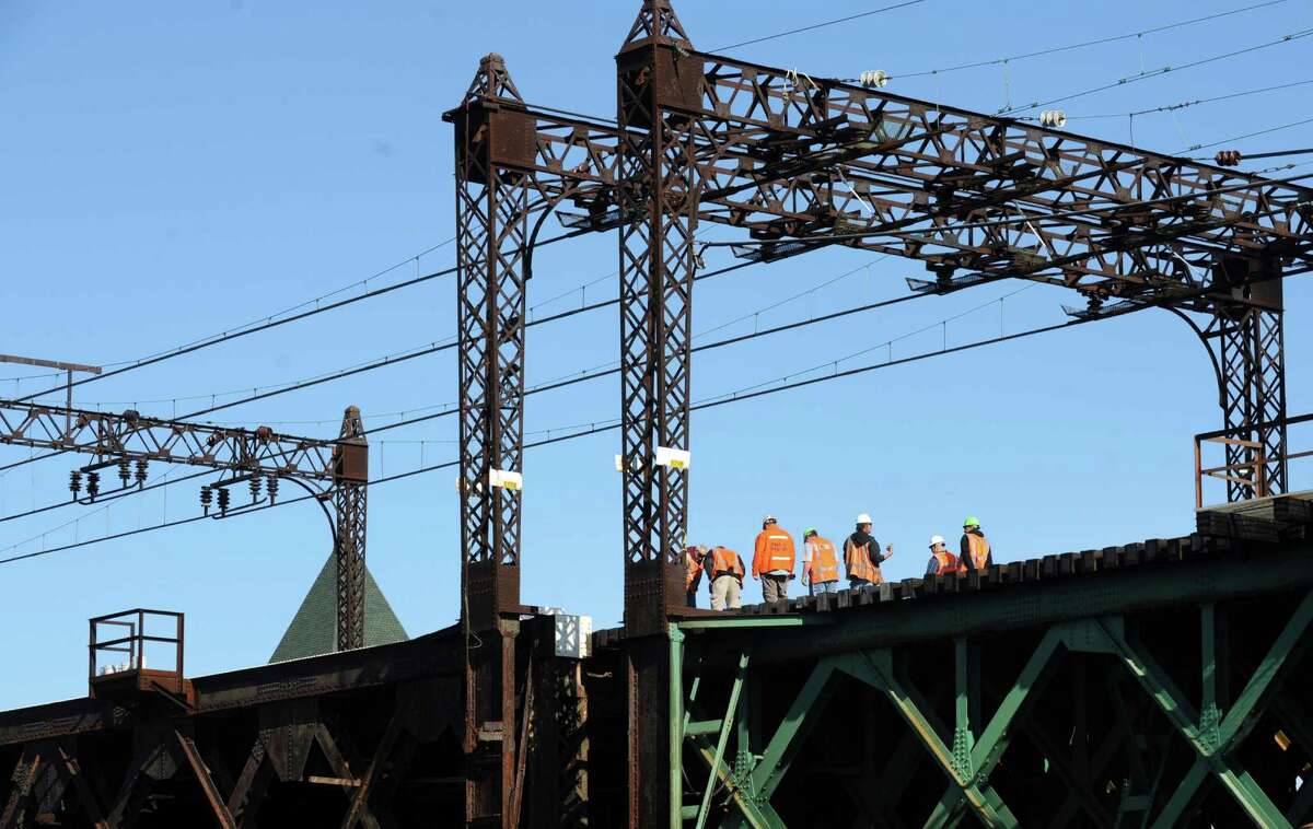 Metro-North workers repair the railroad swing bridge over the Norwalk River in Norwalk, Conn. on Thursday, May 29, 2014. The Walk Bridge failed to close just after 4 a.m., causing major delays on the railroad and on the highways in Connecticut.Trains were stopped at various points and limited shuttle buses ran between East Norwalk and South Norwalk. Eastbound service from Stamford was suspended, while only limited westbound trains were available from South Norwalk. The repairs were completed and service resumed just before 9 a.m.