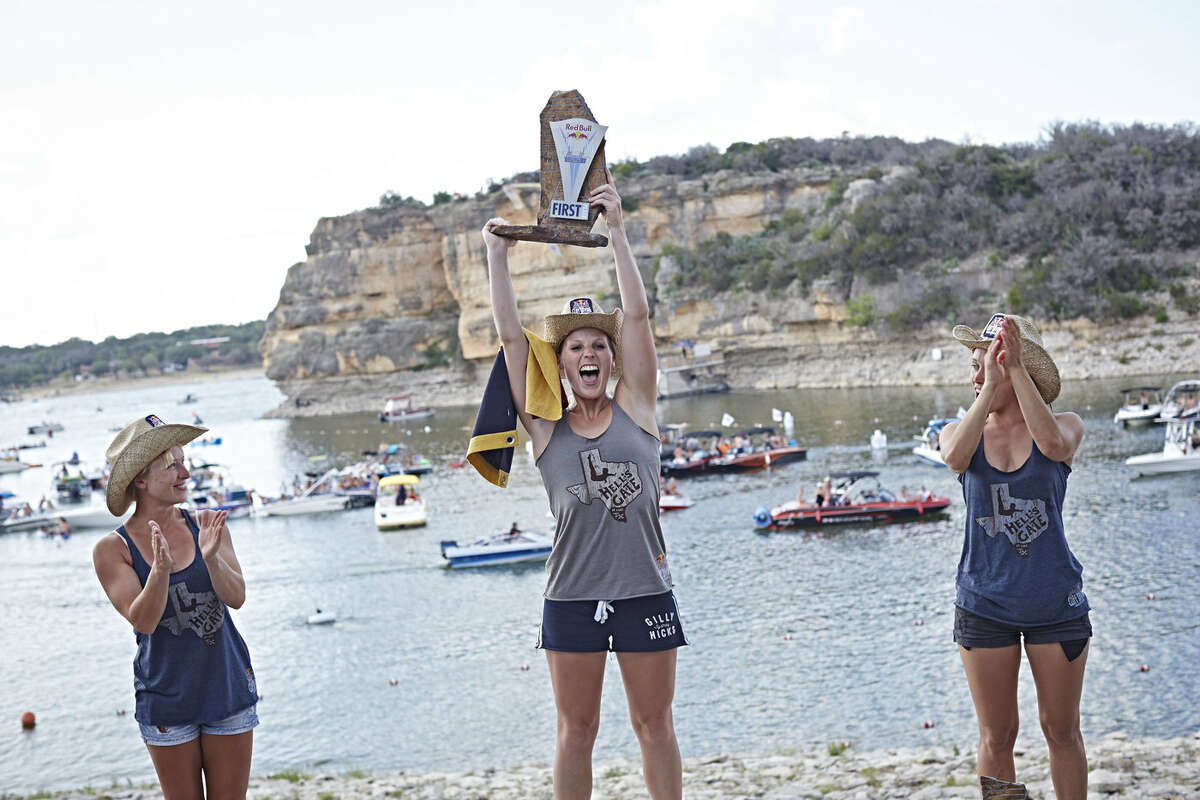 Cesilie Carlton and Rachelle Simpson of the USA celebrate with Anna Bader of Germany during the award ceremony of the second stop of the Red Bull Cliff Diving World Series at Possum Kingdom Lake, Texas, USA on June 7th 2014.