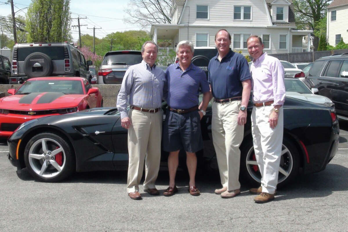 Getting ready to give away a 2014 Corvette Stingray are, from left, Leo Karl III, president of Karl Chevrolet, of New Canaan; Mark Curtis, co-owner of Splash Car Wash; Chris Fisher, co-owner of Splash Car Wash; and Steve Karl, vice president of sales for Karl Chevrolet.